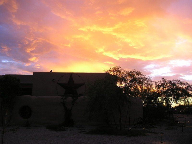 A sunset over a building with a star on it