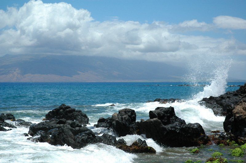 Waves crashing against the rocks on the shore of the ocean