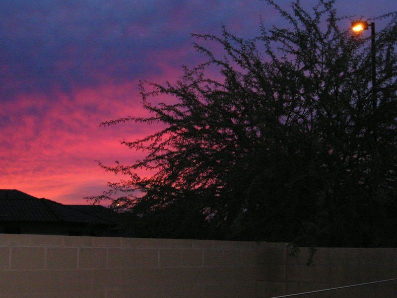A sunset with a street light in the foreground