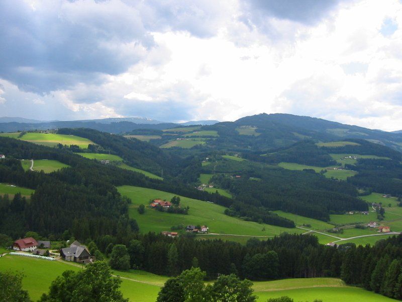 A view of a valley with mountains in the background