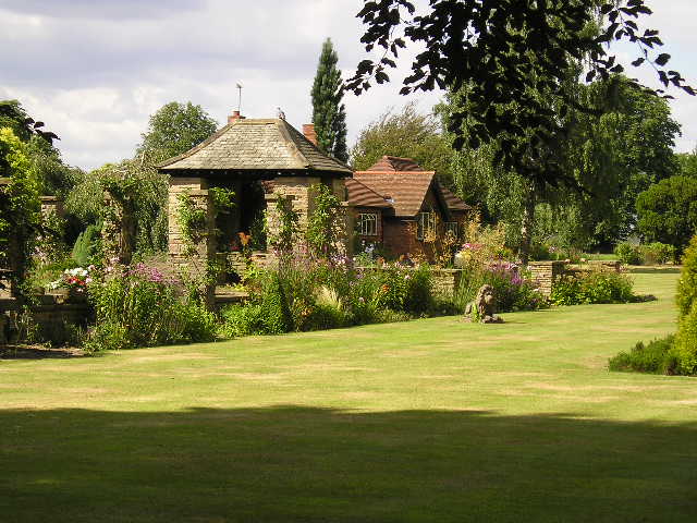 A garden with a gazebo in the middle of it