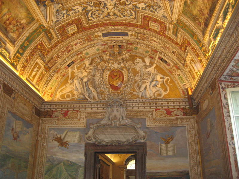 A room with a ceiling that has a lot of paintings on it