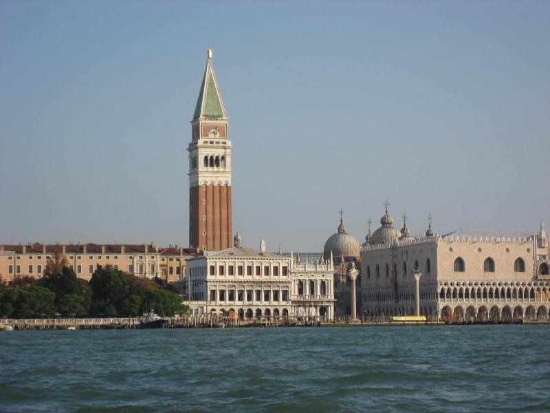 A large building with a bell tower in the background