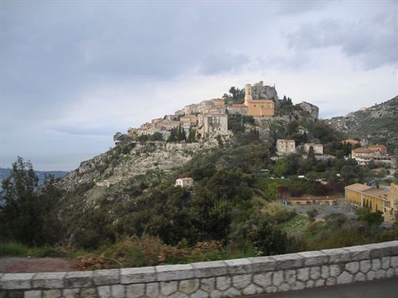 A castle on top of a hill with a brick wall in the foreground