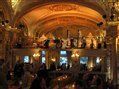 A blurry picture of a restaurant with people sitting at tables.
