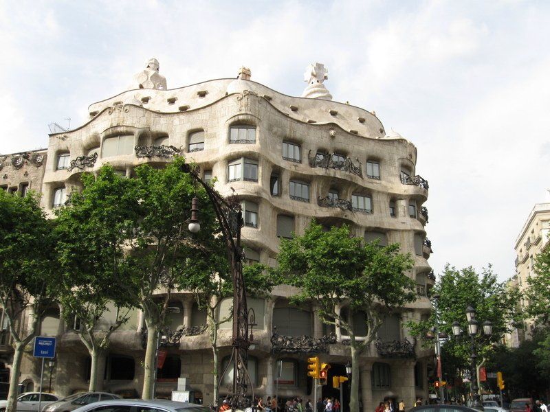 A large building with a lot of windows and trees in front of it.