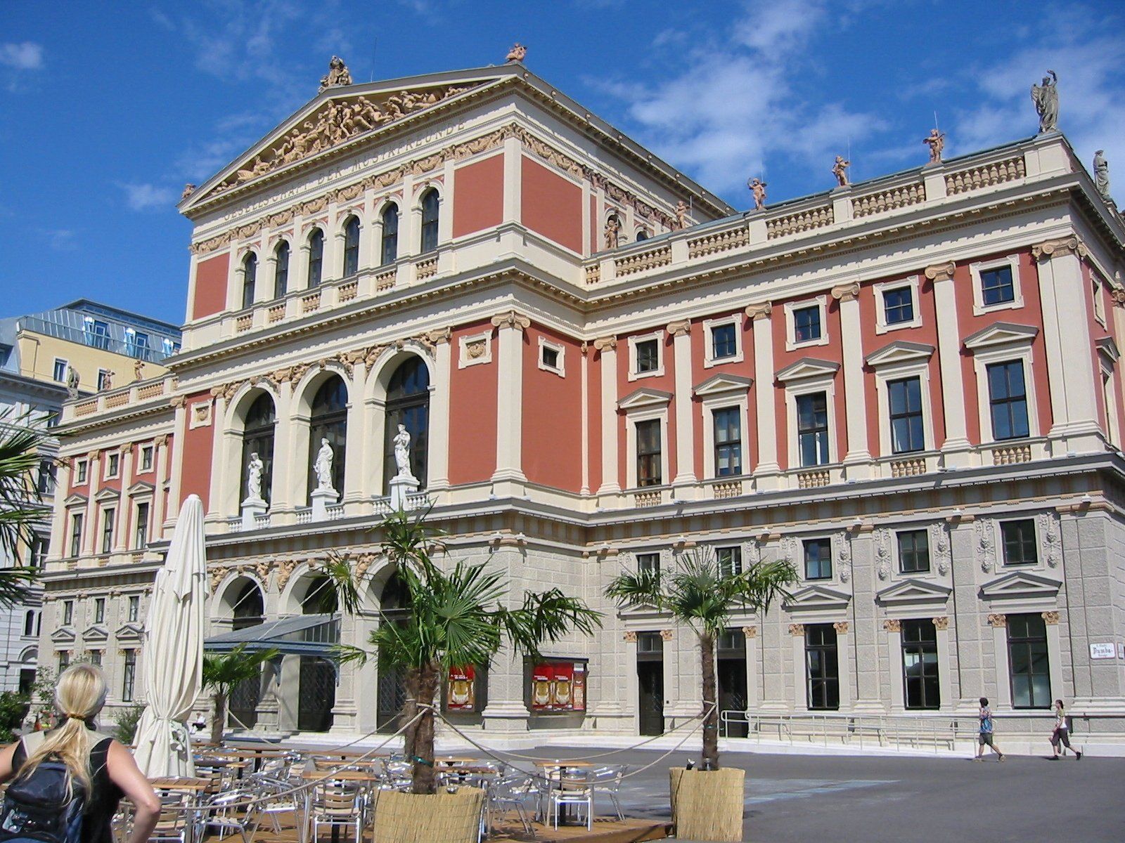 A large building with palm trees in front of it