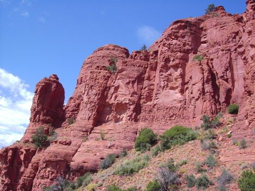 A large rock formation with a blue sky in the background