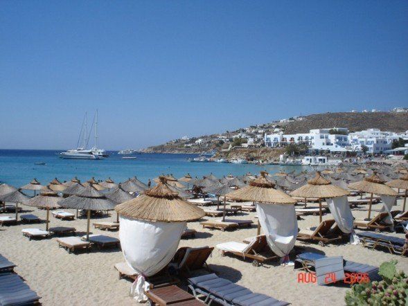 A beach with a lot of chairs and umbrellas on it