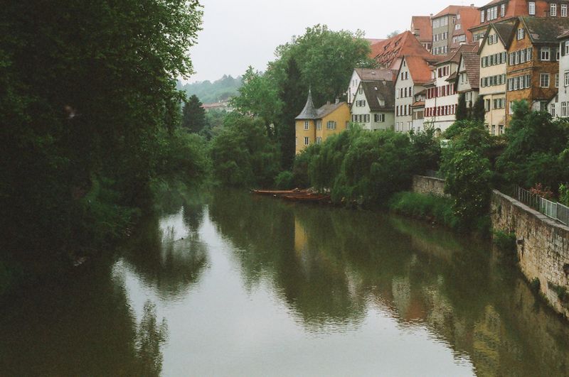 A river runs through a small town with houses on the shore