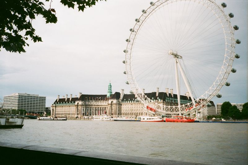 A large ferris wheel is in the middle of a body of water
