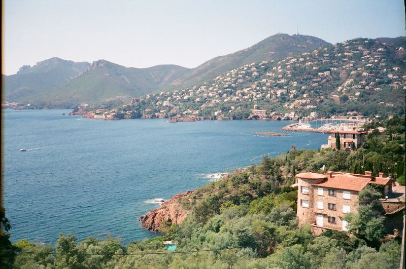 A large body of water surrounded by mountains and trees