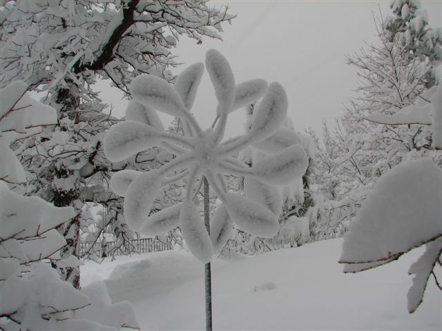 A snowflake made out of snow is standing in the snow