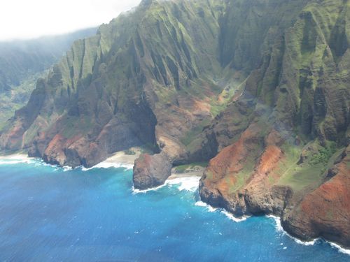 An aerial view of a cliff overlooking a body of water