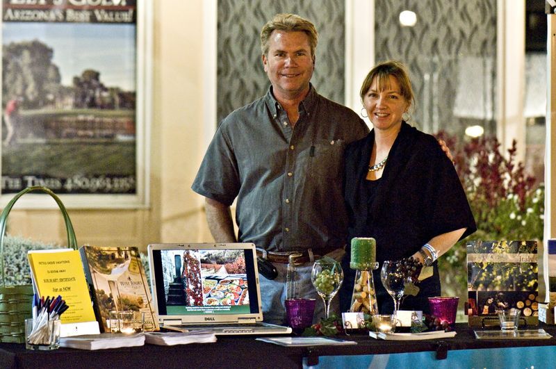 A man and a woman standing in front of a table