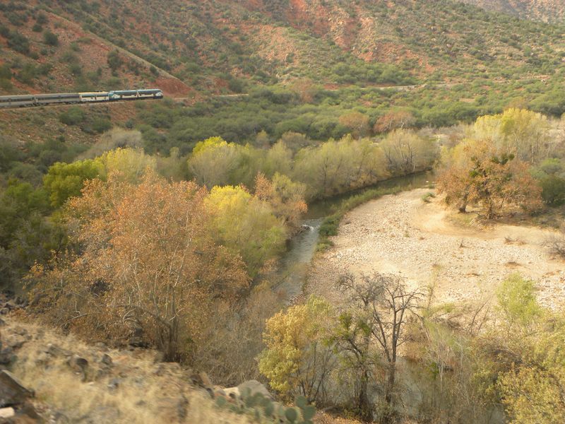 A train is going over a river in the mountains