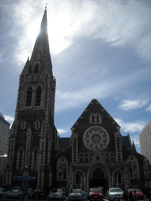 A church with cars parked in front of it on a sunny day