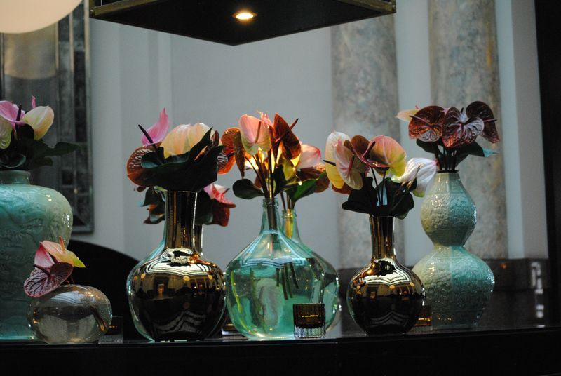 A row of vases with flowers in them on a table