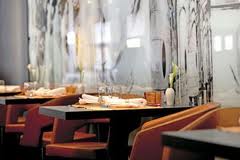 A row of tables and chairs in a restaurant.
