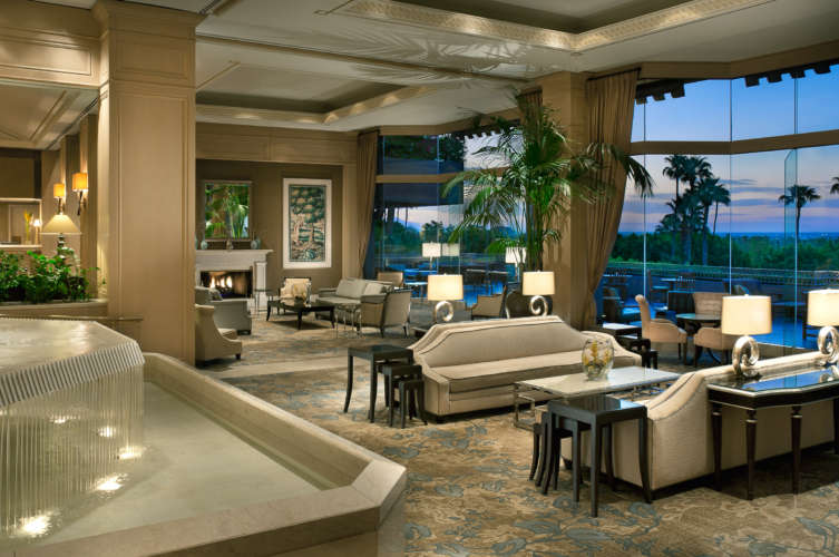 A large living room filled with furniture and a fountain.