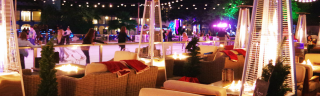 A blurry picture of a restaurant with a lot of chairs and tables.