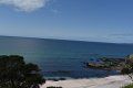 A beach with a view of the ocean on a sunny day.
