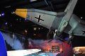 A model airplane is hanging from the ceiling in a museum.