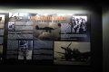 A blurred image of a wall with a lot of pictures on it.