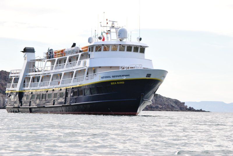 A large cruise ship is floating on top of a body of water.