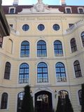 A large building with a lot of windows and arched windows.