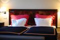 A bed with two pillows on it in a hotel room.