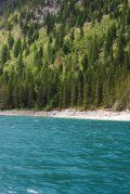 A large body of water surrounded by trees and mountains.