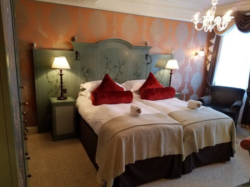 A hotel room with two beds and a chandelier