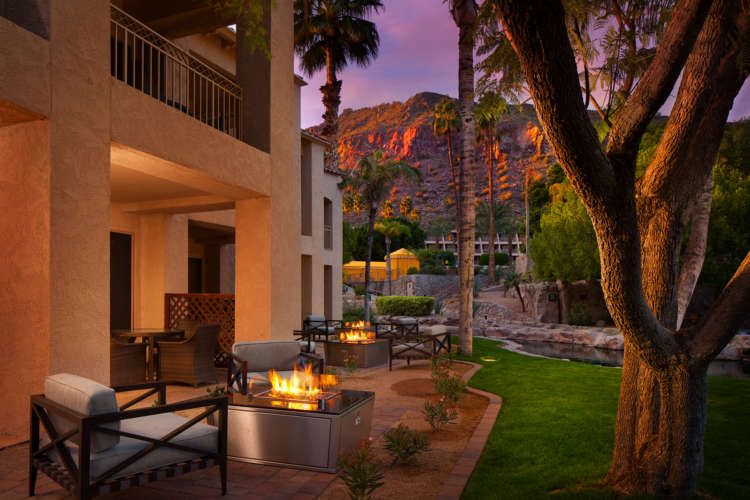 There is a fire pit in the backyard of a house.