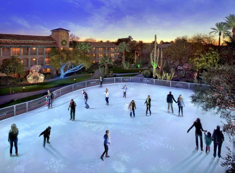 A group of people are ice skating on a rink.