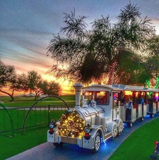 A train with christmas lights on the front of it