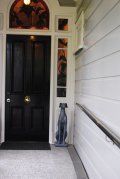 There is a statue of a dog in front of the door.