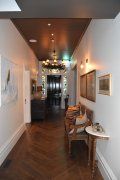 A long hallway with a couch and a table in it.