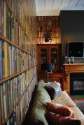 A living room with a couch , fireplace and bookshelves.