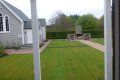 A view of a lush green yard from a window.