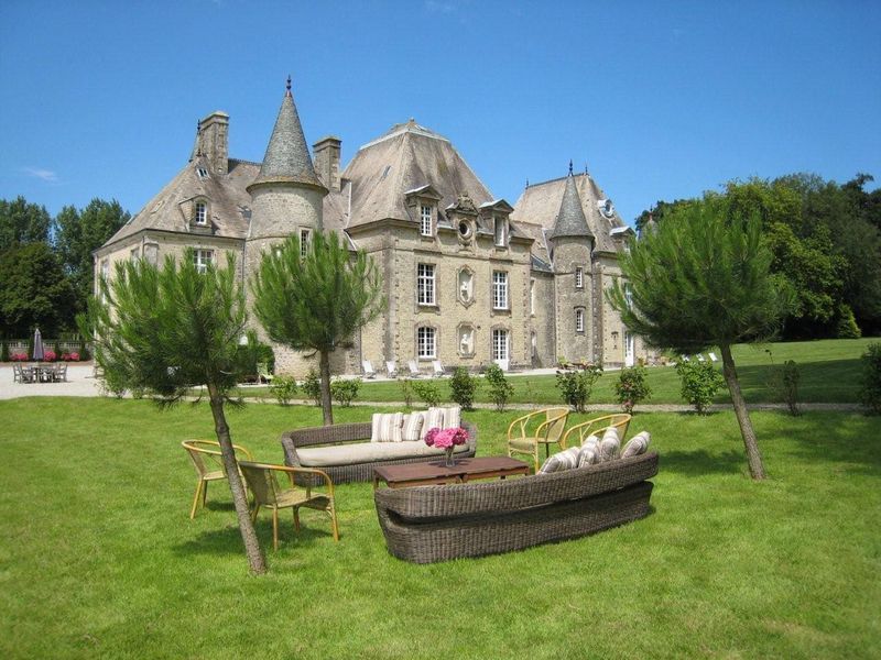 A large castle with a lot of furniture in front of it