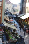 An aerial view of a city street with tables and chairs.