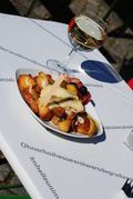 A plate of food and a glass of wine on a table.