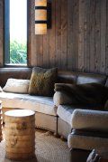 A living room with a couch , table , and window.