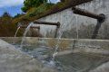 A close up of a fountain with water coming out of it.
