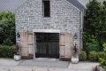 A brick house with a garage and a driveway in front of it.