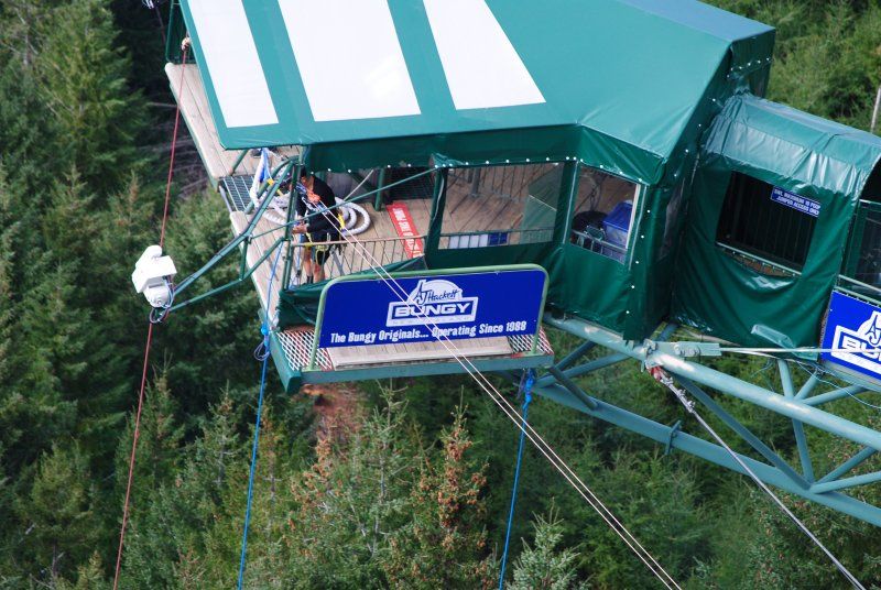 An aerial view of a bungee jumping platform in the woods