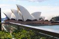 A view of the opera house from a balcony overlooking the water.
