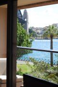 A balcony with a view of a body of water and a bridge.