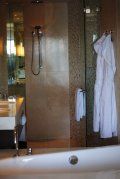 A bathroom with a bathtub , sink , and shower.
